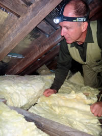 Checking the roof cavity during a property inspection